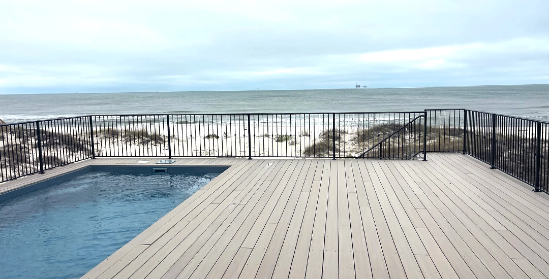 Deck with iron railing around pool