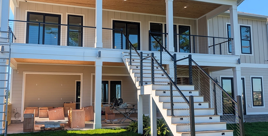 Exterior view of reliable railing on two story home stairs and balcony
