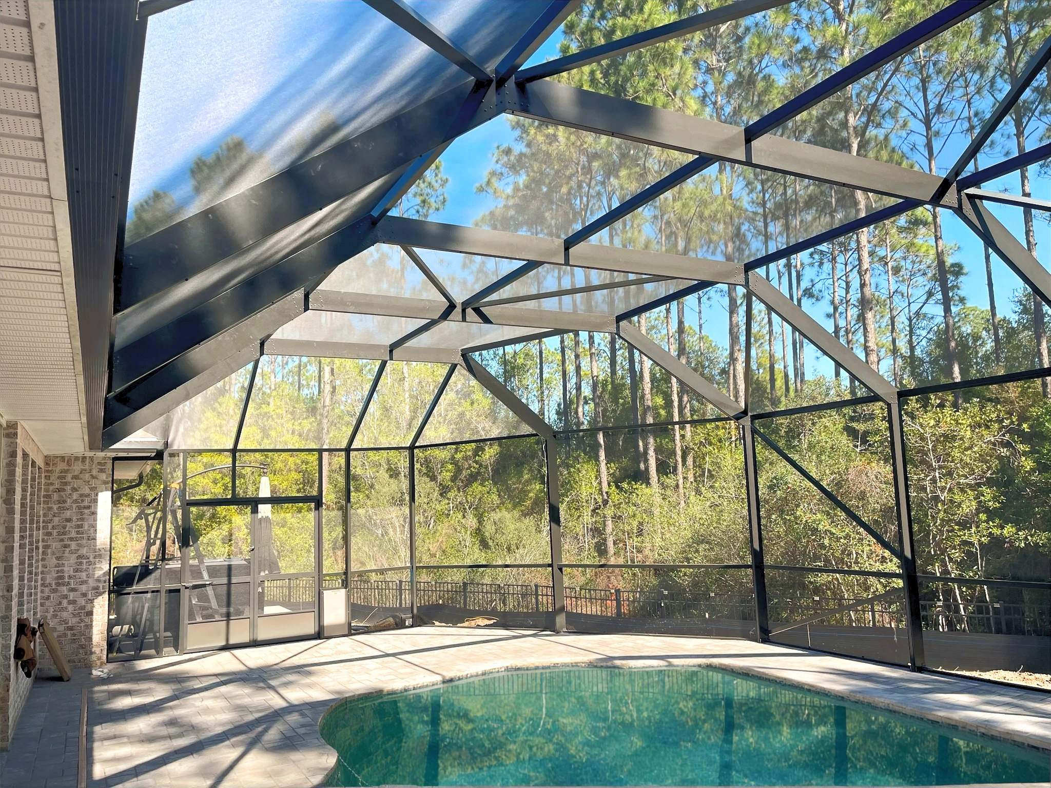 Enclosure around pool at home in wooded area
