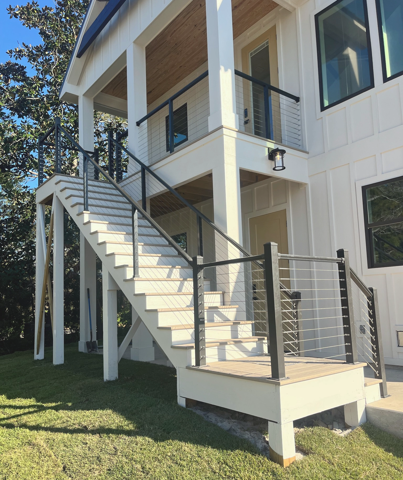 Stairwell with custom railing on two story white home